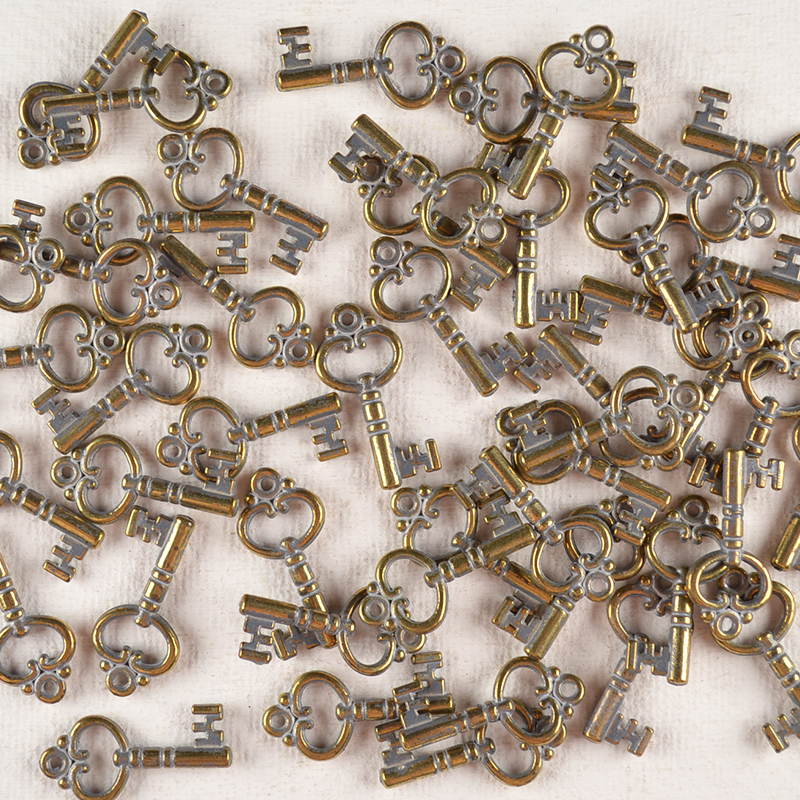 Bedel Sleuteltje Brons/Zilver – Met Metal Look