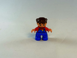 Meisje met blauwe tuinbroek, rood shirt en bruin haar Duplo