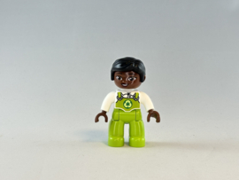 Vrouw getint met groene overal Duplo