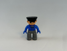 Machinist grijze broek met blauwe jas en zwarte pet Duplo