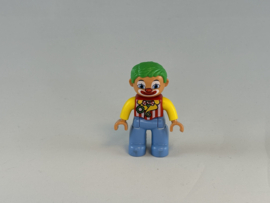 Clown licht blauwe broek, rood shirt met gele mouwen en groene krullen Duplo