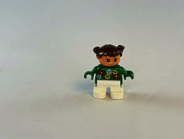 Meisje met witte broek, groene trui met bloemen en bruin haar Duplo