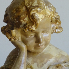 Plaster statue reading girl