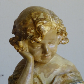 Plaster statue reading girl