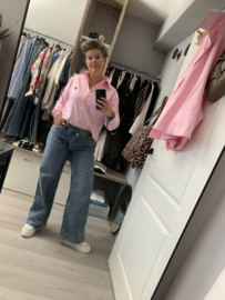 Jeans scheve knoop