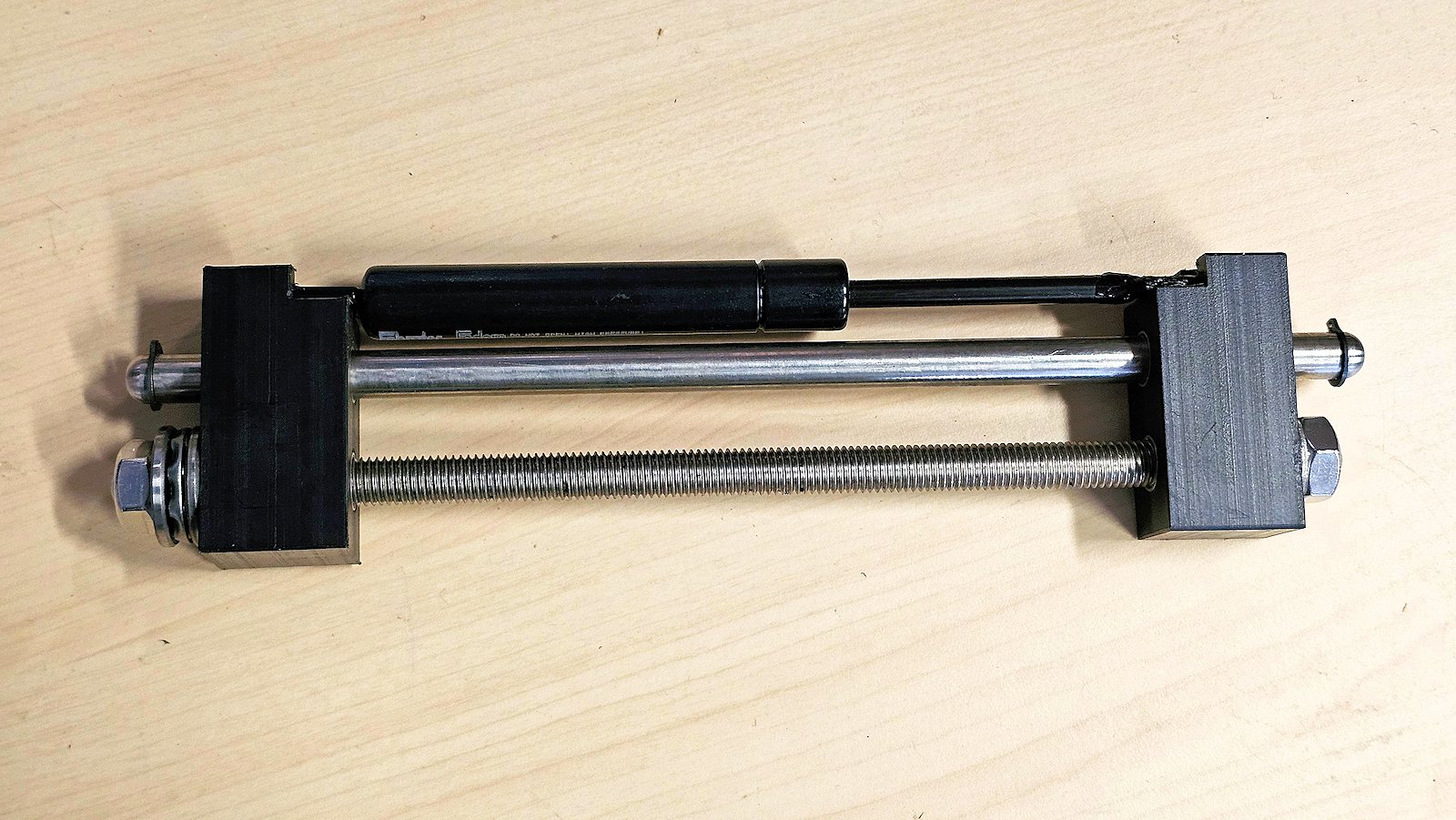 Gas spring compressor