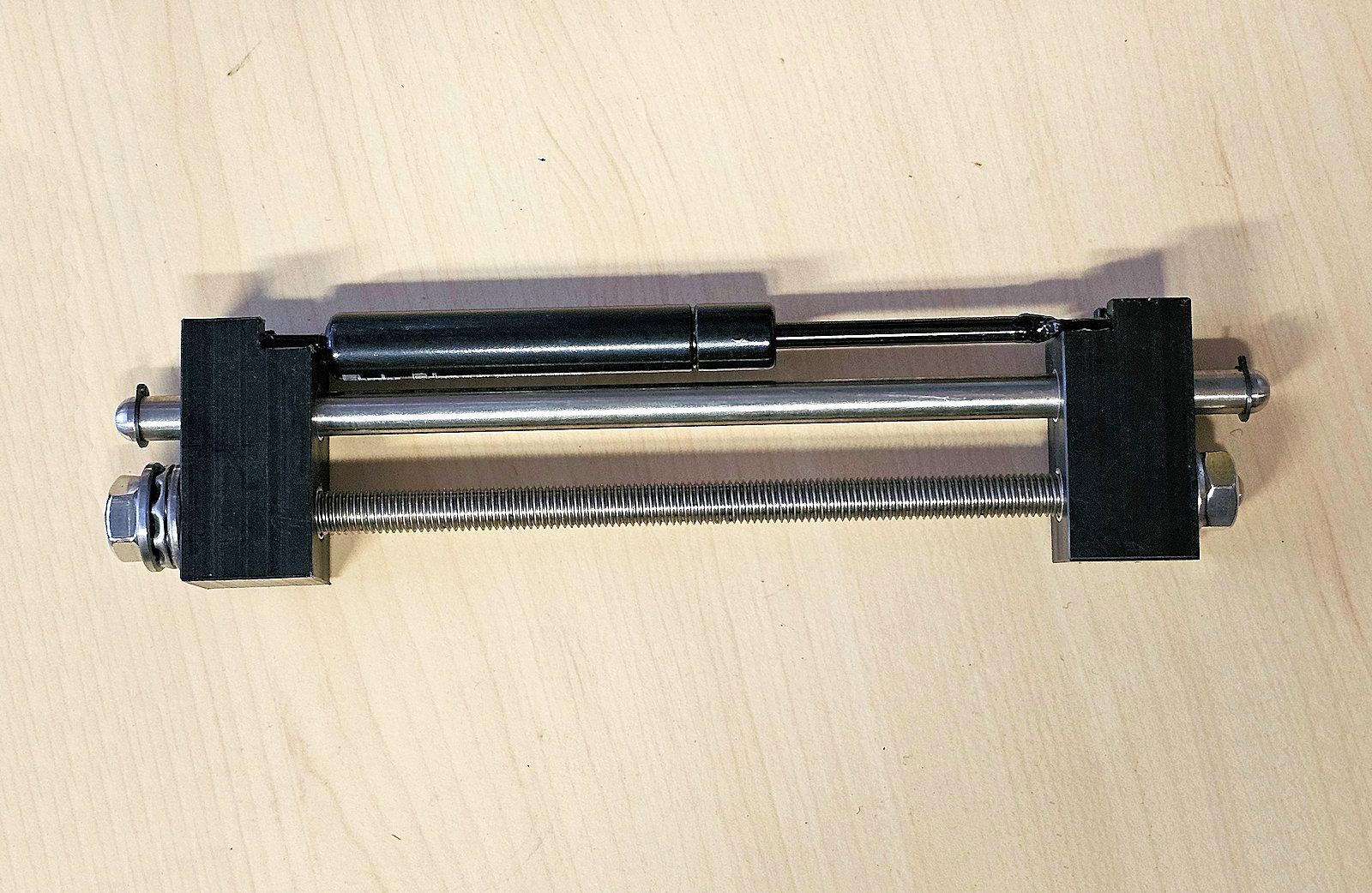 Gas spring compressor