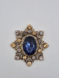 Broche met blauwe steen