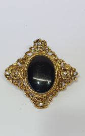 Broche met zwarte steen