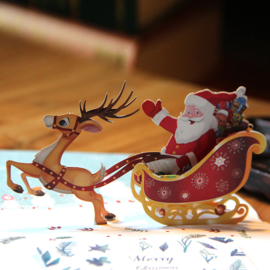 3D pop up Kerstkaart  Vrolijke Kerstman op een arrenslee met rendier (vanaf 10 stuks)