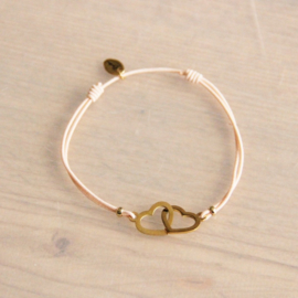 Elastische armband met verbonden hart - perzik / goud