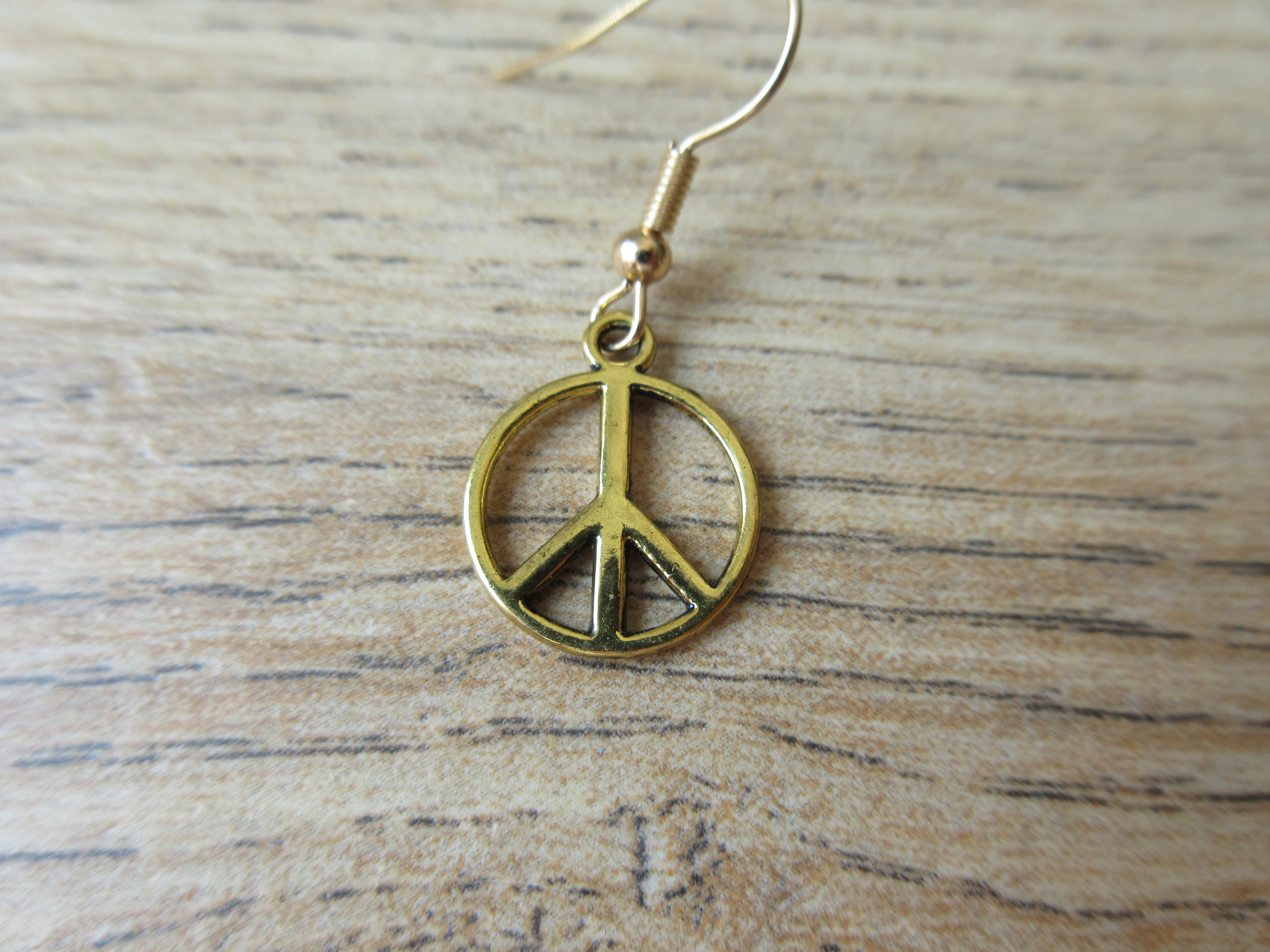 Peaceteken goudkleurig
