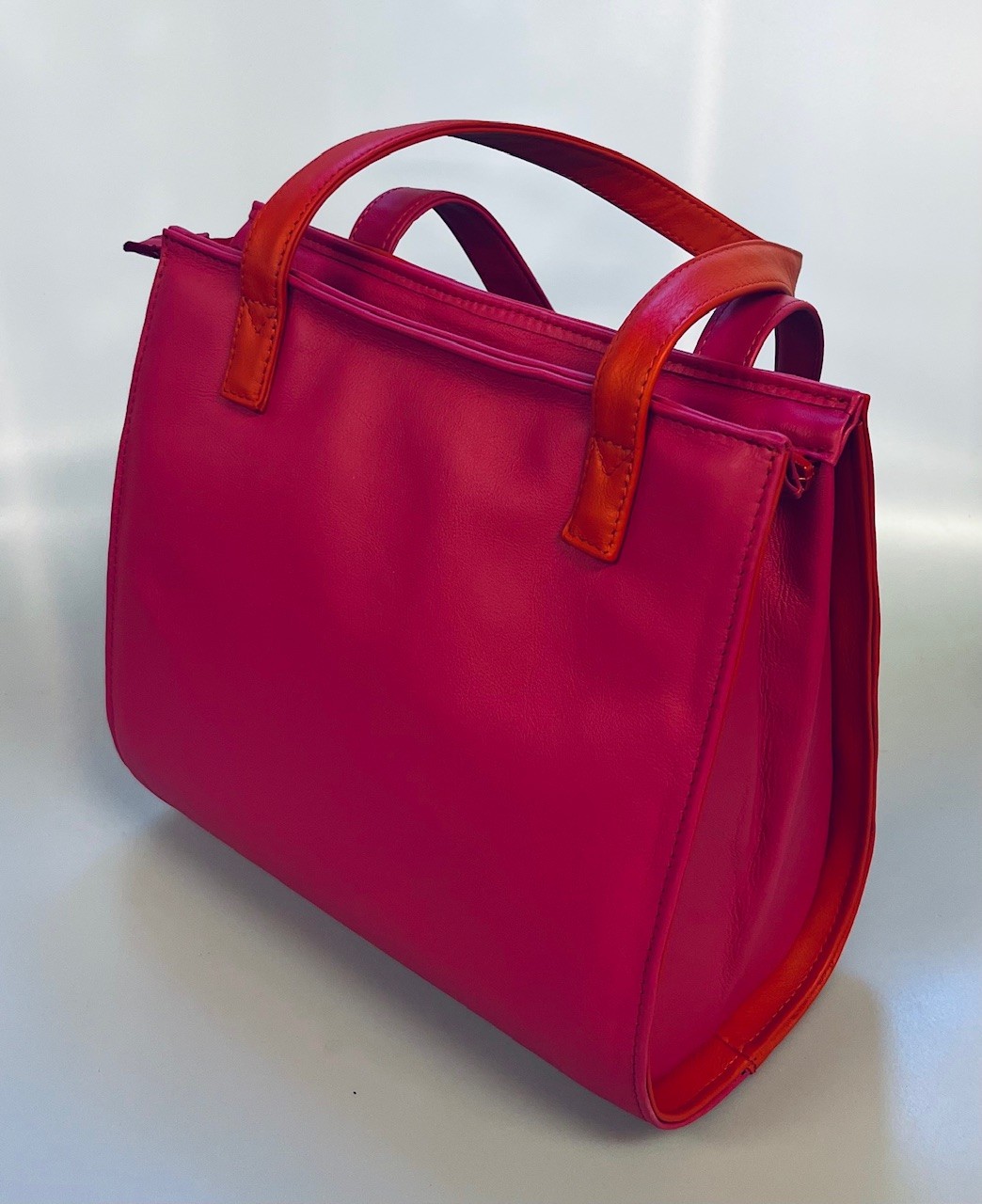 Schoudertas in rood en fuchsia