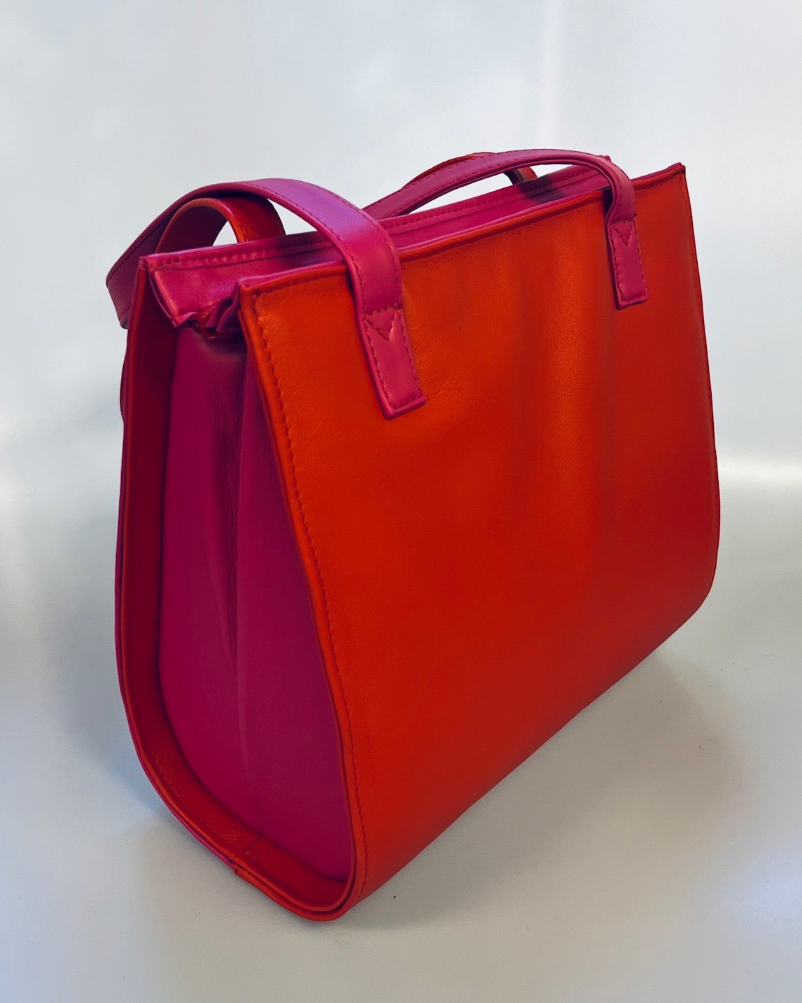Schoudertas in rood en fuchsia