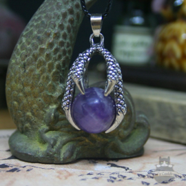 Goth dragonclaw necklace holding an Amethyst