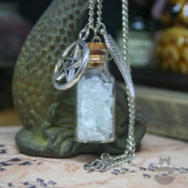 Bottle with crystals and pentagram necklace