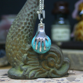 Spiritual necklace of two hands holding a Turquoise sphere