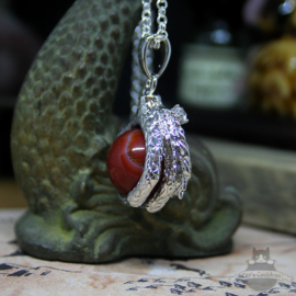 Dragonclaw necklace holding a red Agate