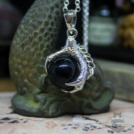 Dragonclaw necklace holding a black Agate