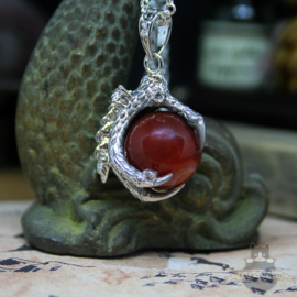 Dragonclaw necklace holding a red Agate