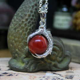 Dragonclaw necklace holding a red Agate