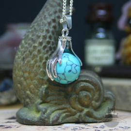 Spiritual necklace of two hands holding a Turquoise sphere