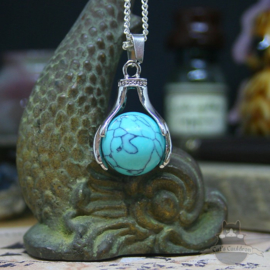 Spiritual necklace of two hands holding a Turquoise sphere