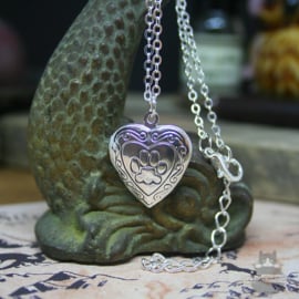 Heart shaped locket with cat pawprint silver colored