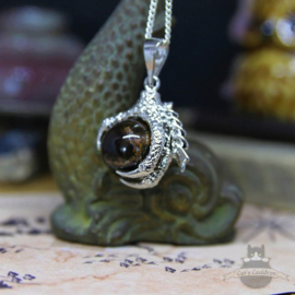 Dragonclaw necklace holding a Tiger Eye stone