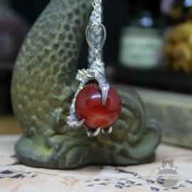 Dragonclaw necklace holding a red Agate