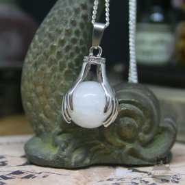 Spiritual necklace of two hands holding a Rock Crystal sphere