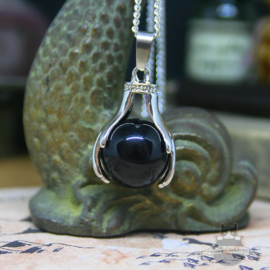 Spiritual necklace of two hands holding a Black Agate sphere