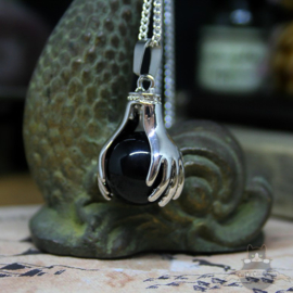 Spiritual necklace of two hands holding a Black Agate sphere