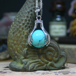 Spiritual necklace of two hands holding a Turquoise sphere