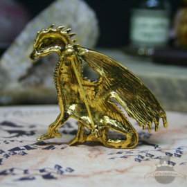 Gold colored dragon brooch decorated with stones