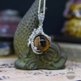 Dragonclaw necklace holding a Tiger Eye stone