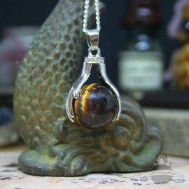 Spiritual necklace of two hands holding a Tiger Eye sphere