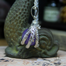 Dragonclaw necklace holding an Amethyst