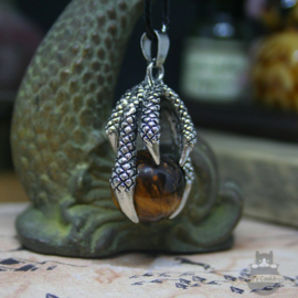 Goth dragonclaw necklace holding a Tiger's Eye