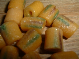 Mooie okergele kralen met donkerrode en groene versiering