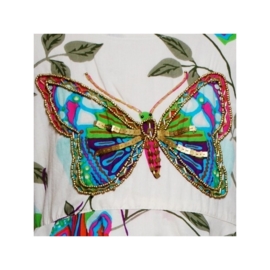 Geweldig wit puntenjurkje met glitters en muntjes blauwe vlinder