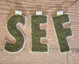 Letterslinger teddy bouclé op vilt