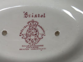 Engels rood Crown Ducal Bristol sauskom op vaste onderschotel
