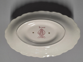 Engels rood Crown Ducal Bristol sauskom op vaste onderschotel