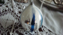 Oude grote zilveren kerstbal met blauwe strepen en witte sneeuwstrepen.