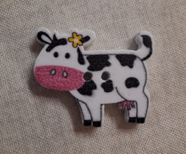 Kunstof knoop in de vorm van een zwartbonte koe met gele ster op het oor