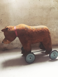 Antique bear on wheels