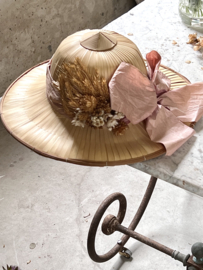 Old safari hat with dried flowers