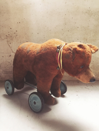 Antique bear on wheels