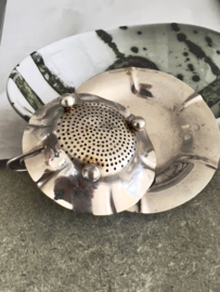 Old tea strainer with plate